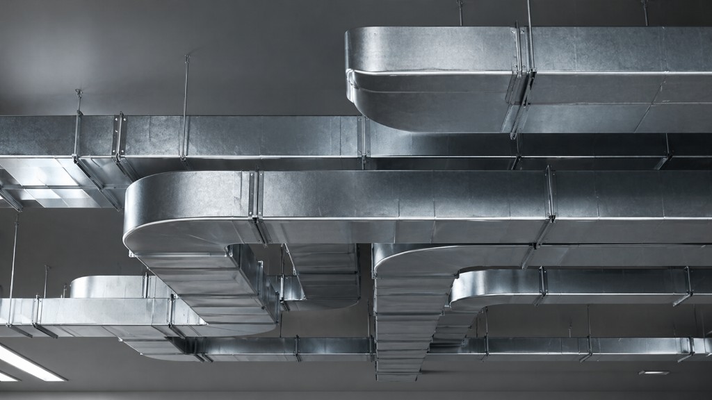 Commercial galvanized steel ductwork suspended from ceiling — radius bends, sealed flanges, engineered air distribution